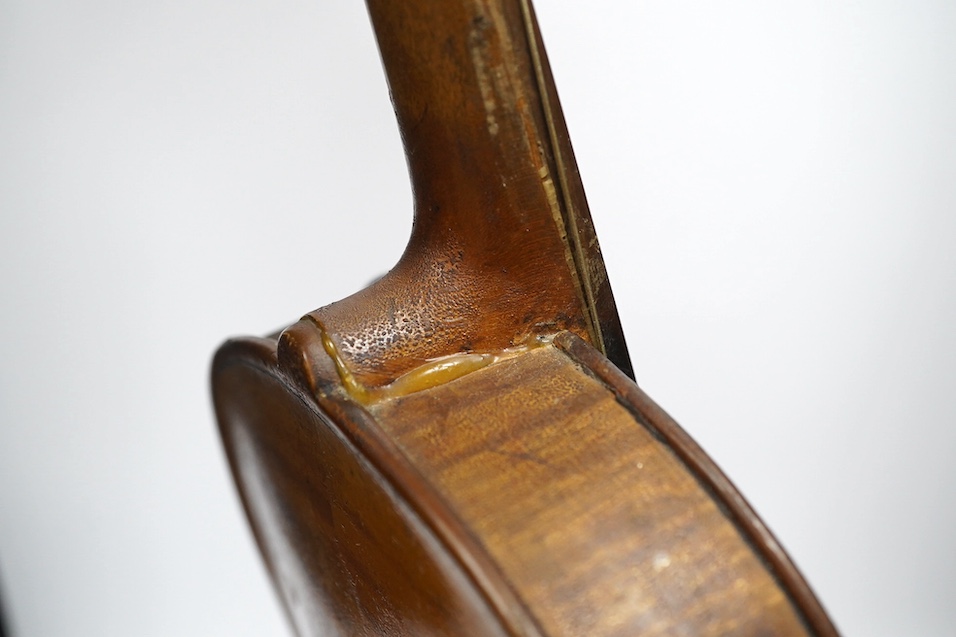 Two late 19th or early 20th century violins, one with case, back of largest measures 36cm. Condition - poor to fair